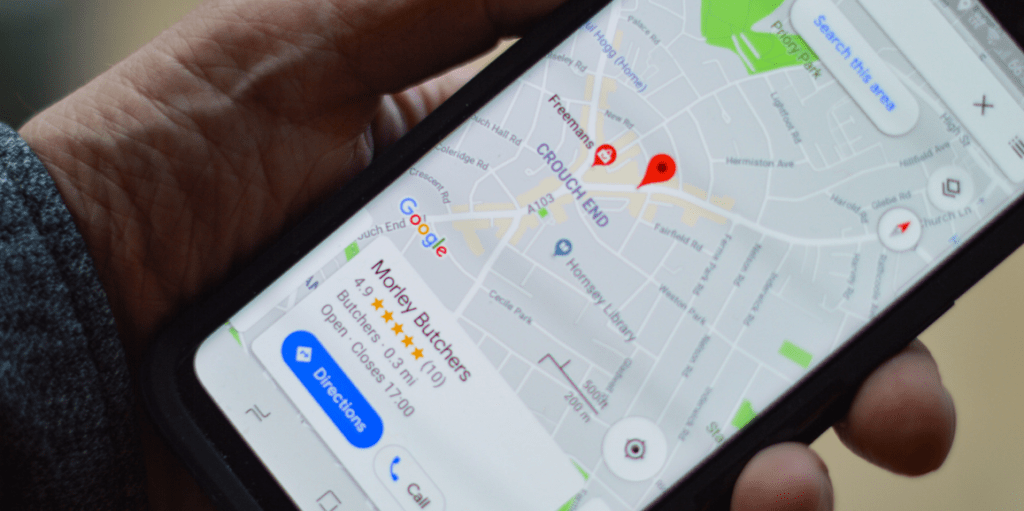 Man holding phone showing Google customer review ratings